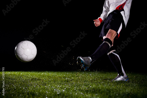 soccer player kicking the ball