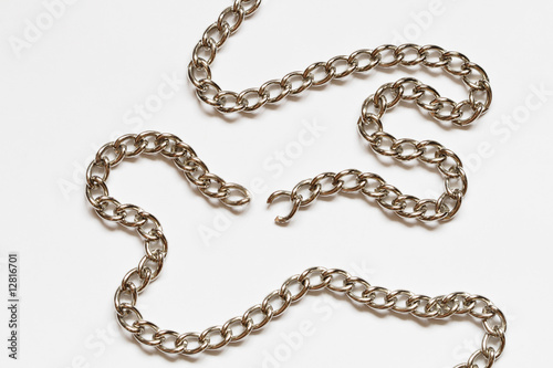 Nice torn chain with shadow lying on white background