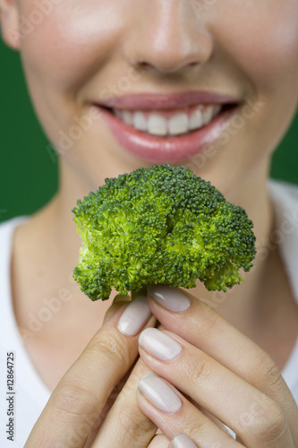 Close up of woman holding broccoli