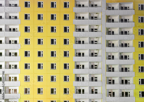 Yellow building with white balconies