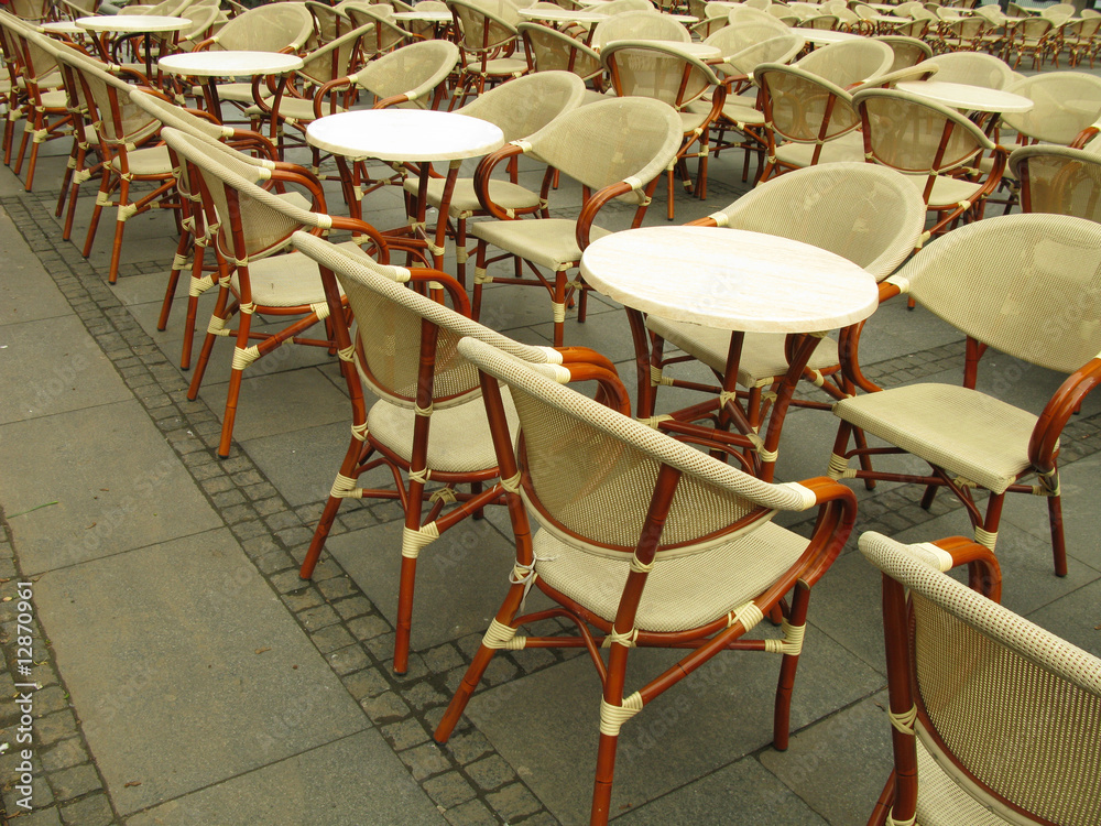 Outdoor part of sidewalk cafe with chairs and tables