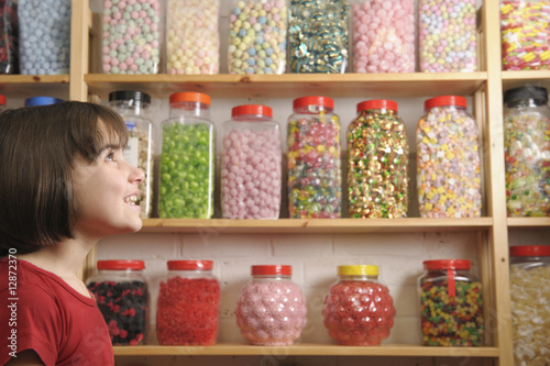 child in sweet shop photo