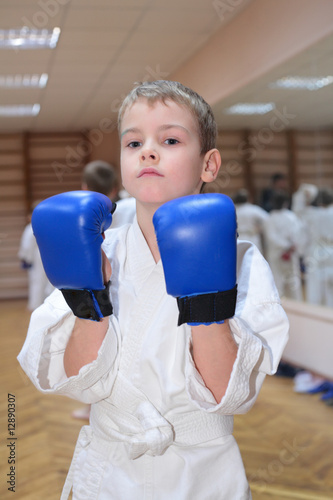 boy in sports hall in boxing gloves © Pavel Losevsky