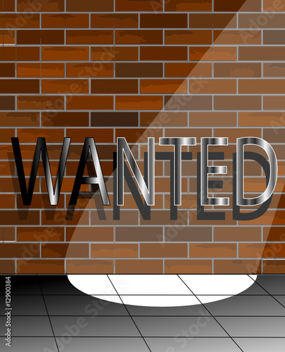 Wanted sign in the spotlight on a brick wall