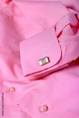 Close-up of cufflink on pink shirt
