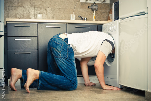 Man Looking inside the washing machine