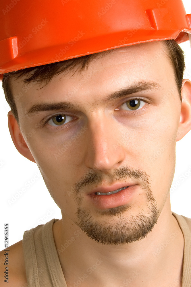 young worker in a red building helmet young worker in a red building helmet