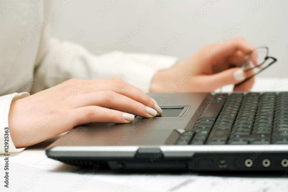 Female hands working at laptop. Female hands working at laptop.