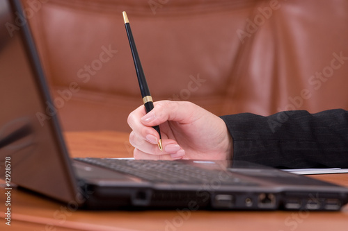 The laptop on a wooden brown table