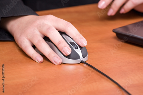 Closeup of a business woman hand working on a computer