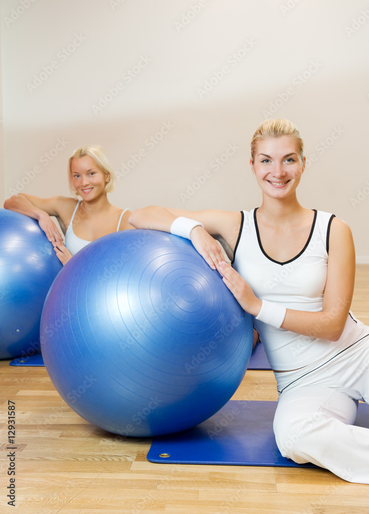 Group of people doing fitness exercise with a ball Group of people doing fitness exercise with a ball