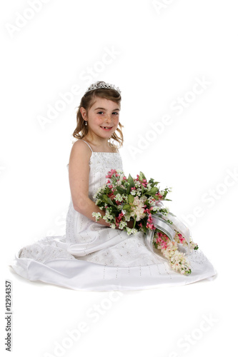 pretty girl in white gown and tiara with bouquet of flowers