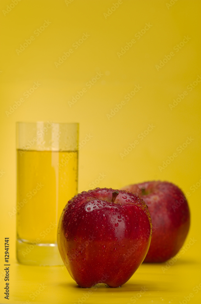 Juicy red apples on a yellow background Juicy red apples on a yellow background
