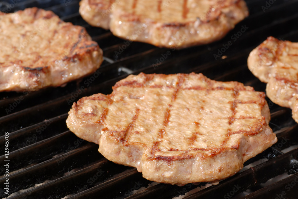 shallow DOF of hamburgers on a barbeque grill