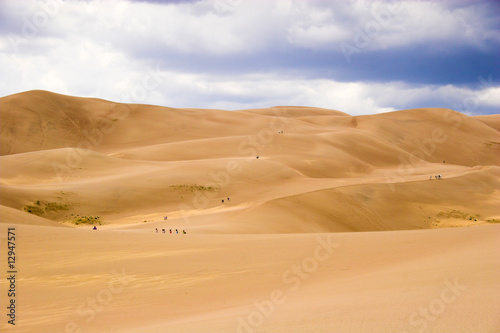 People walking in sand dunes