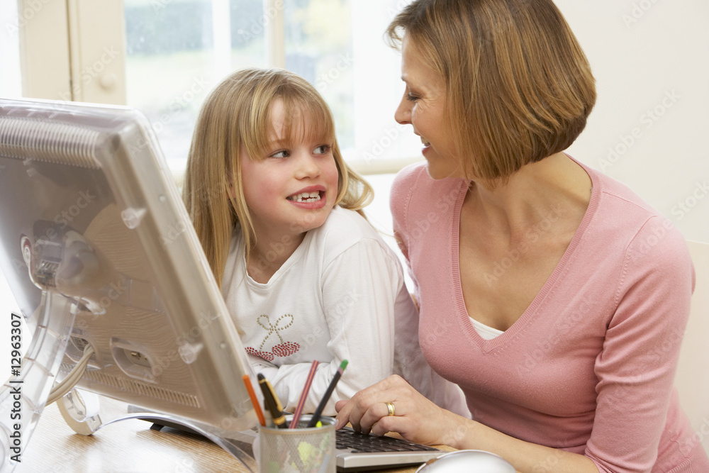 Woman And Daughter Using Computer