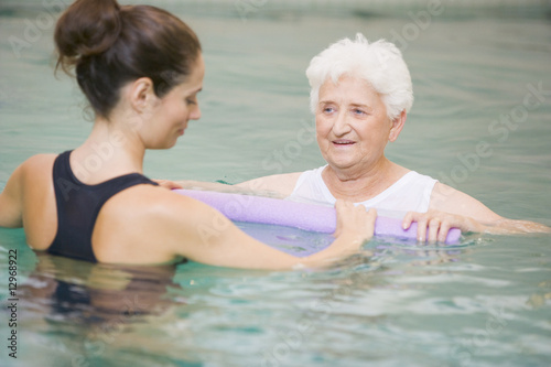 Instructor And Elderly Patient Undergoing Water Therapy photo