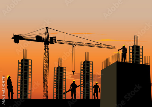 Construction site silhouette with workers at sunset