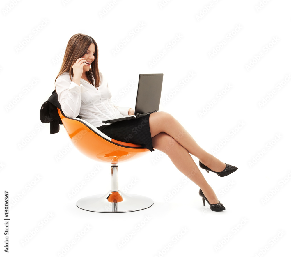 businesswoman in chair with laptop and phone