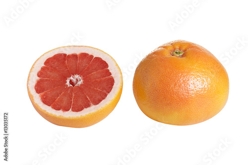 Whole and one piece of grapefruit on a white.