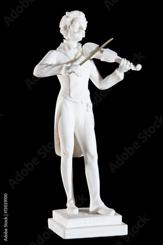 white marble statue of Johann Strauss II isolated on black photo