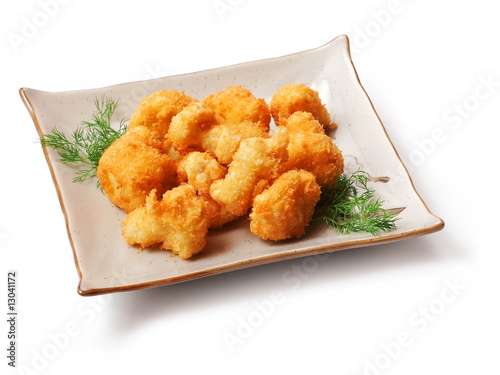 Meat fried in batter, dill in squared plate