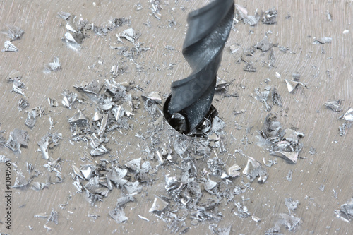 Sctratchy silver steel plate with drill in work