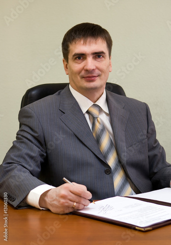 Portrait of the businessman sitting on the workplace