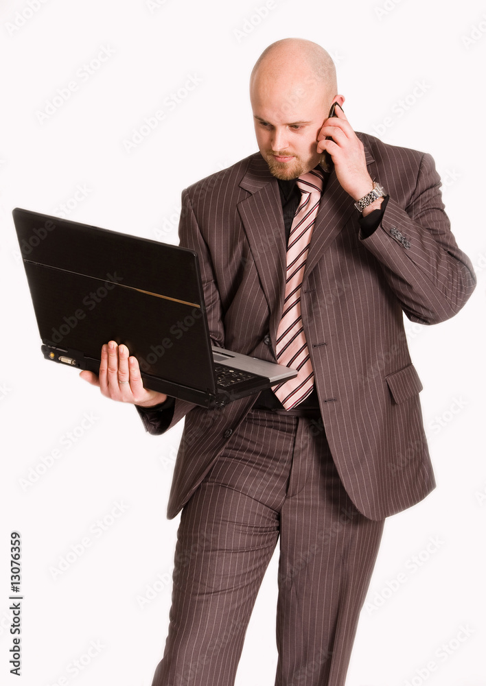 Young businessman holding laptop and making a call Young businessman holding laptop and making a call