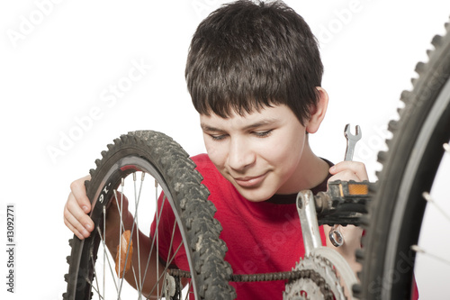boy repairing the bicycle
