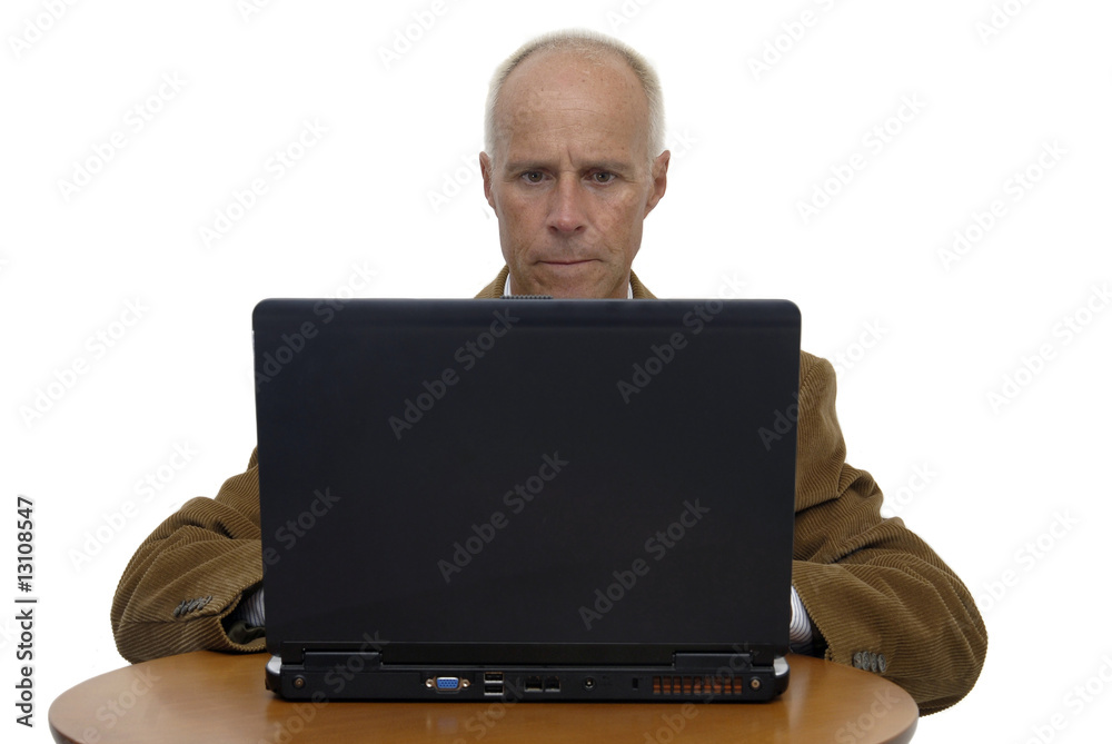 Mature man working in is laptop isolated in white Mature man working in is laptop isolated in white