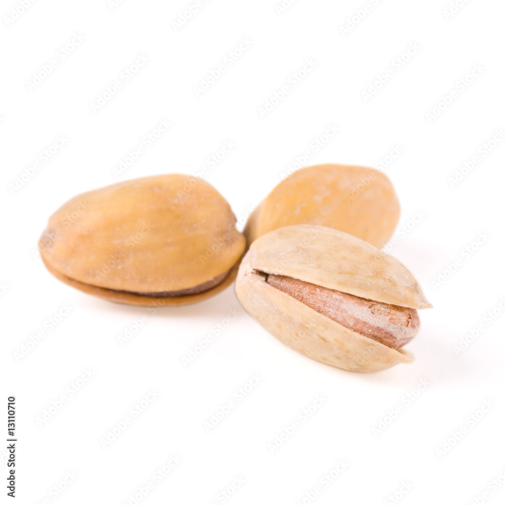 Fototapeta premium Closeup of pistachio nuts on white with clipping path