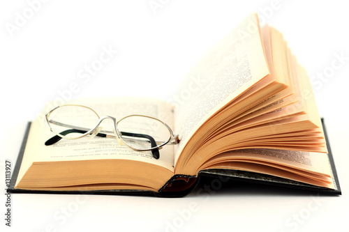 glasses on the open book