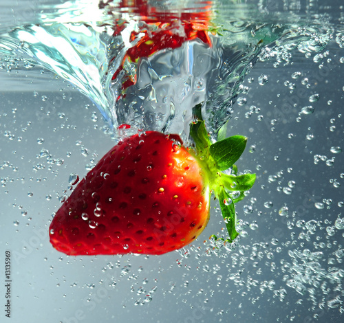 Strawberry falling in water