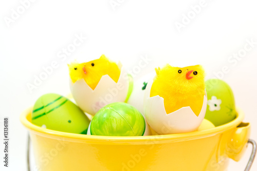 colorful easter eggs in bucket isolated on white © anna karwowska