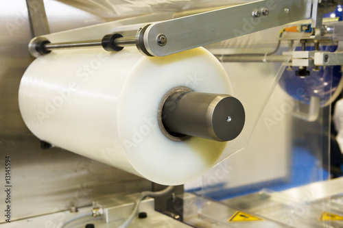 Conveying machine beltlinewith roll of polyethylene film photo