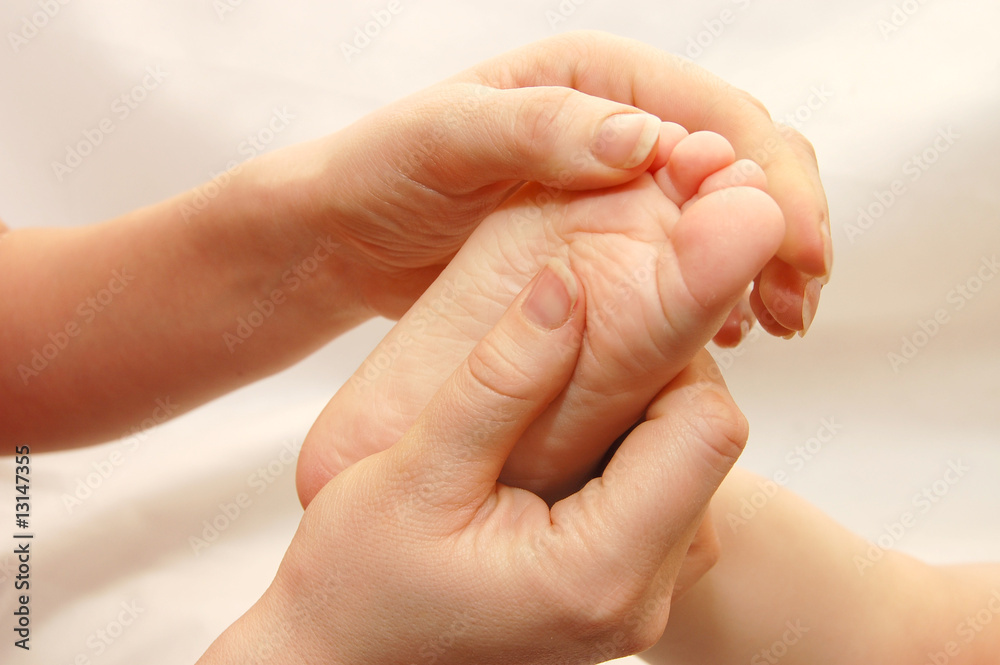 Female hands massage a children's foot Female hands massage a children's foot