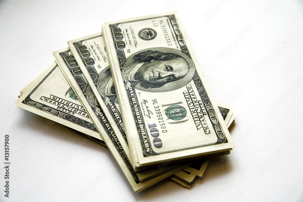 pile of dollar banknotes on a white background pile of dollar banknotes on a white background