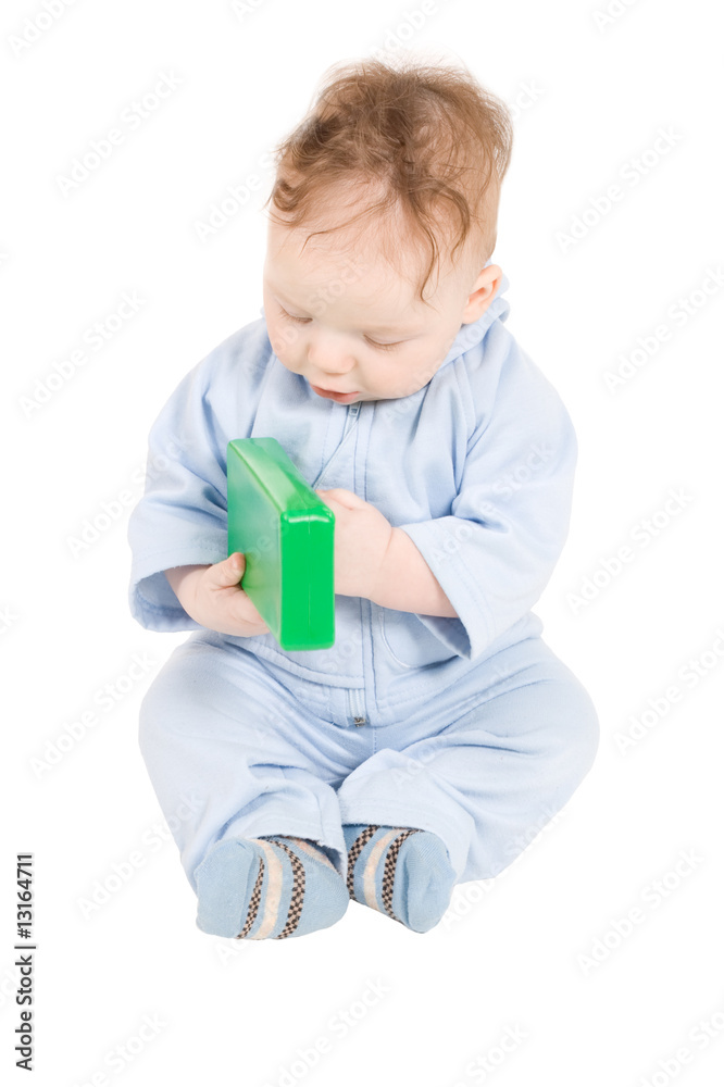 Baby playing with green plastic block Baby playing with green plastic block