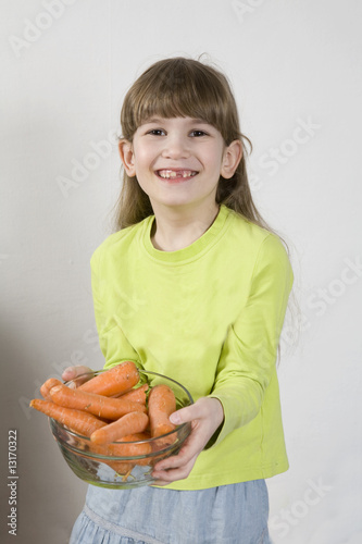 little cute girl holding carrot photo