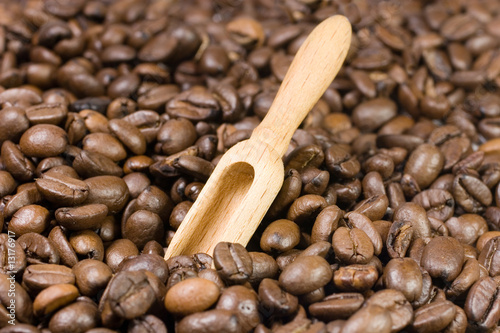 Small wooden scoop among coffee beans