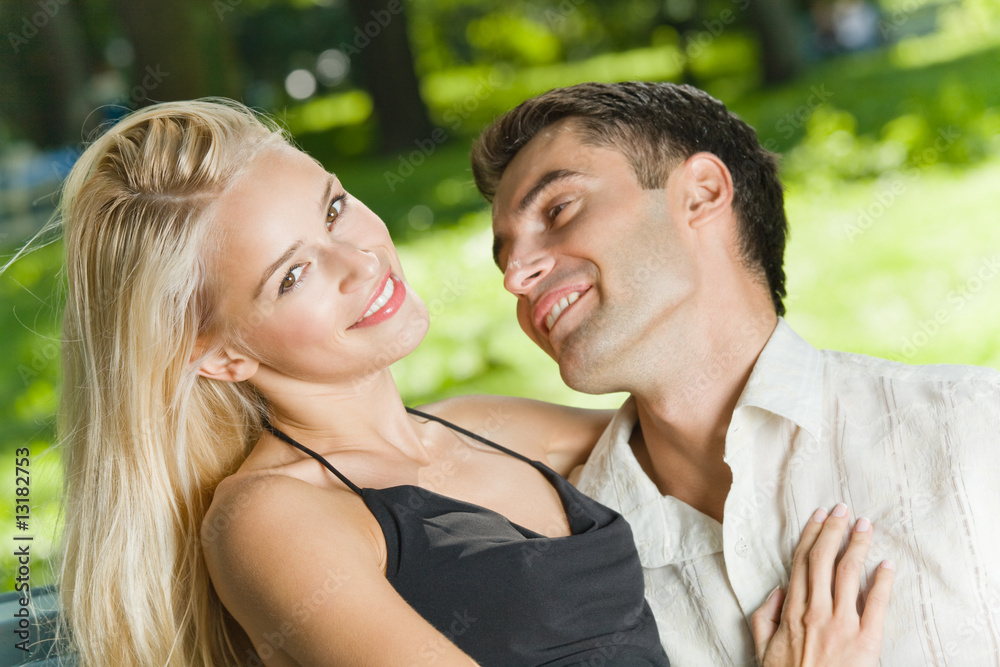 Naklejka premium Young happy amorous couple together, outdoors