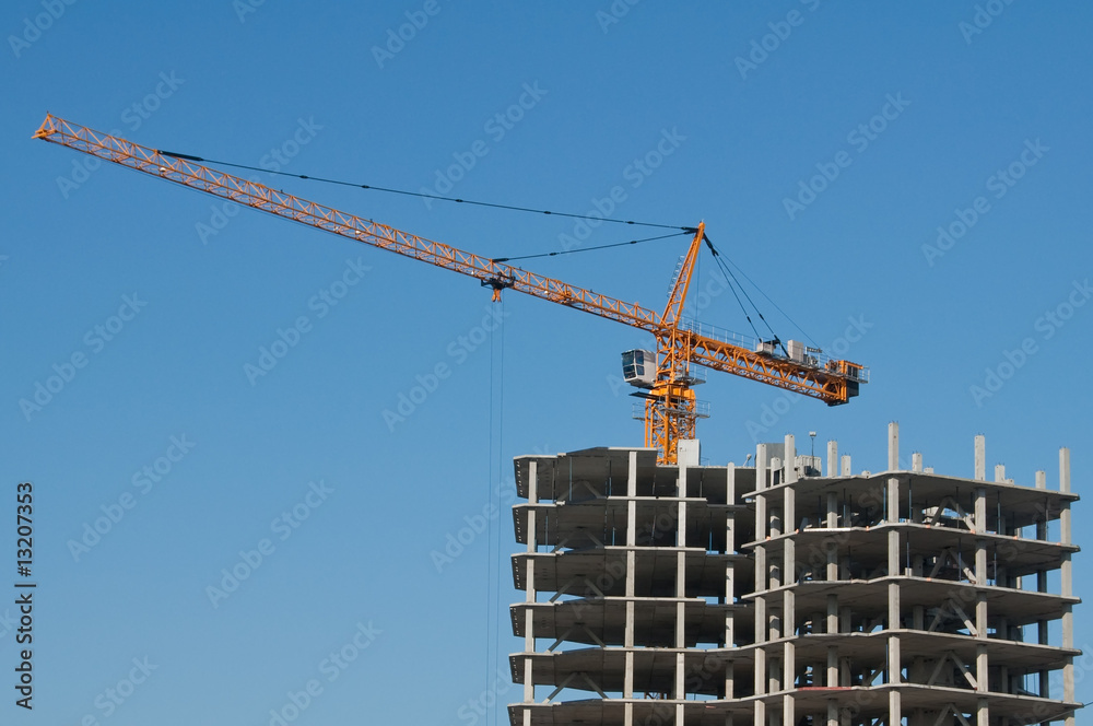 The elevating crane on clear blue sky background