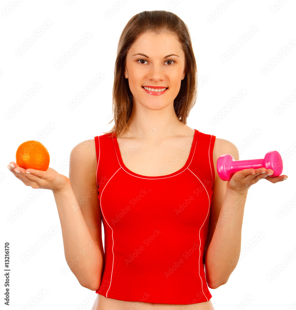 Beautiful girl with an orange and a dumbbell. Isolated on white Beautiful girl with an orange and a dumbbell. Isolated on white