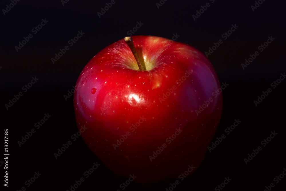 conceptual lit apple on a black background