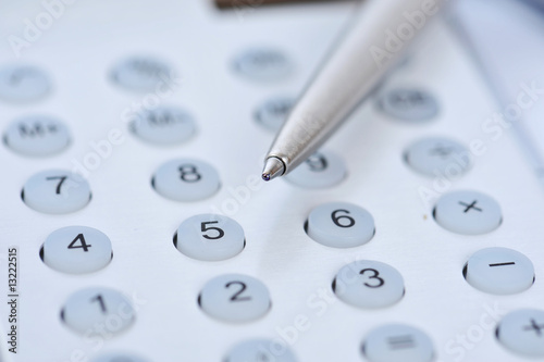 Closeup view of a calculator and pen