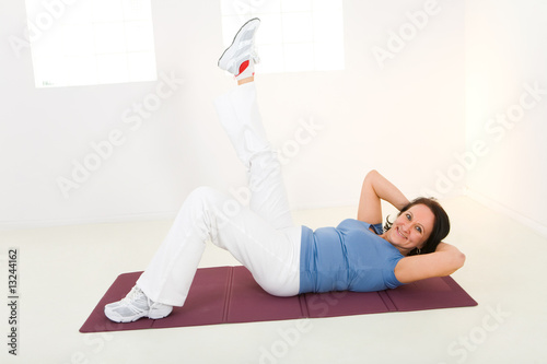 Elder woman working out on mat