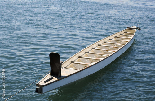 Fototapeta Tied up rowboat on the blue sea