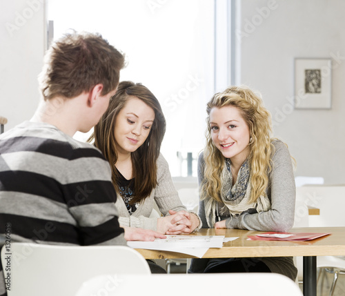 two girls and a man talking