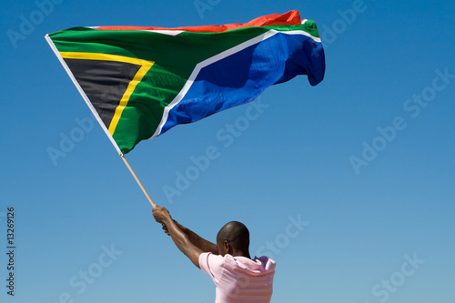 Fototapeta african man waving a south african flag